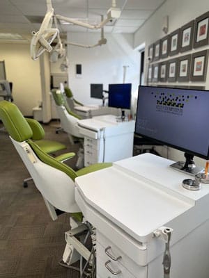 Modern orthodontic treatment room with dental chair, equipment, and monitor at Toombs Orthodontics clinic.